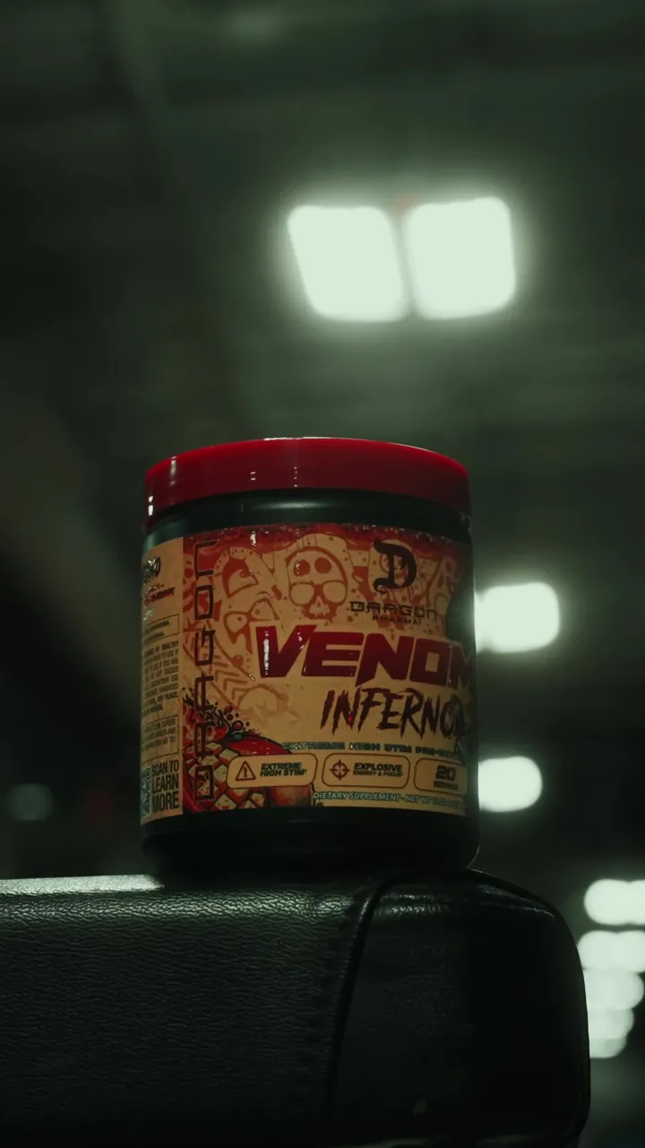 Dragon Pharma Venom Inferno pre-workout tub photographed in a gym