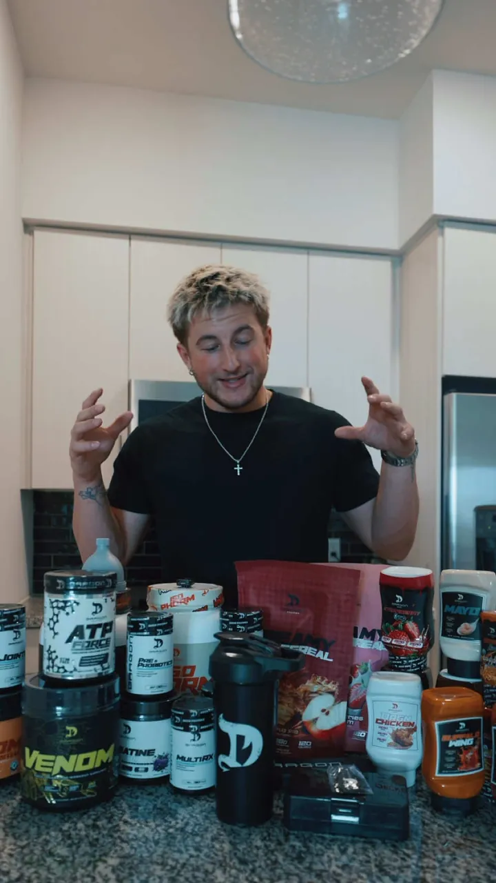 Mayson Brown with a spread of Dragon Pharma supplements in his kitchen